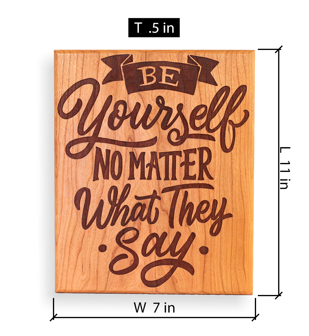 A rectangular wooden sign with the engraved phrase “BE Yourself NO MATTER What They Say.” shown on a white background with dimension labels indicating 7 inches wide, 11 inches tall, and a thickness of .